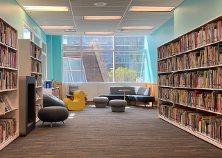Image showing the children's collection on the shelves left and right and showing the furniture with big yellow duck near a sunny window