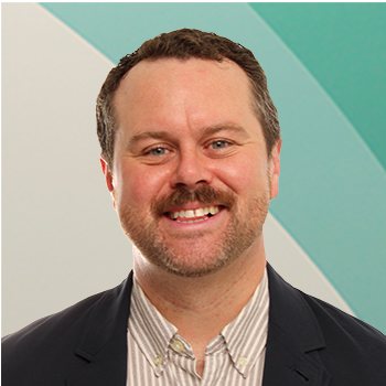 Image of a white man in a green shirt against a cream and green background.